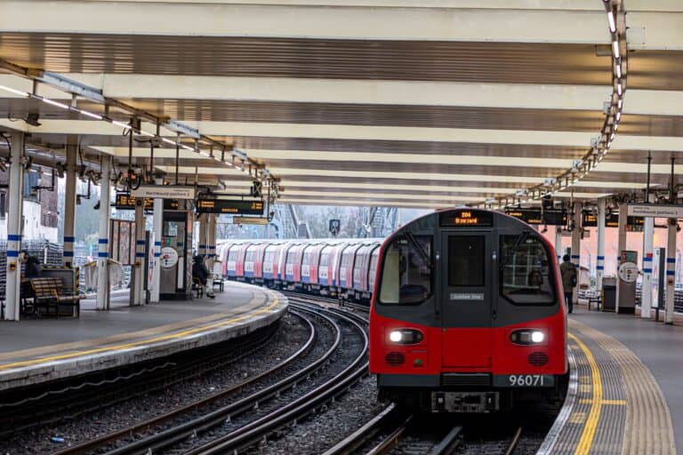 A train approaching the platform in Finchley Road Station in the concept of 'how to use Finchley's public transport'.