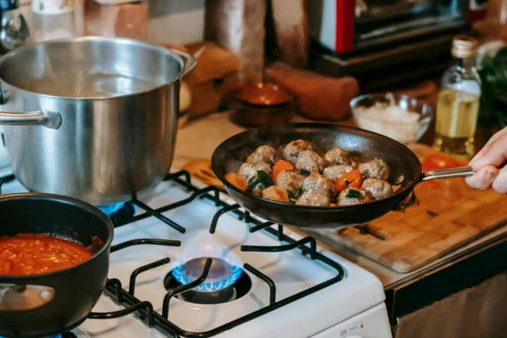 A man is cooking in the kitchen