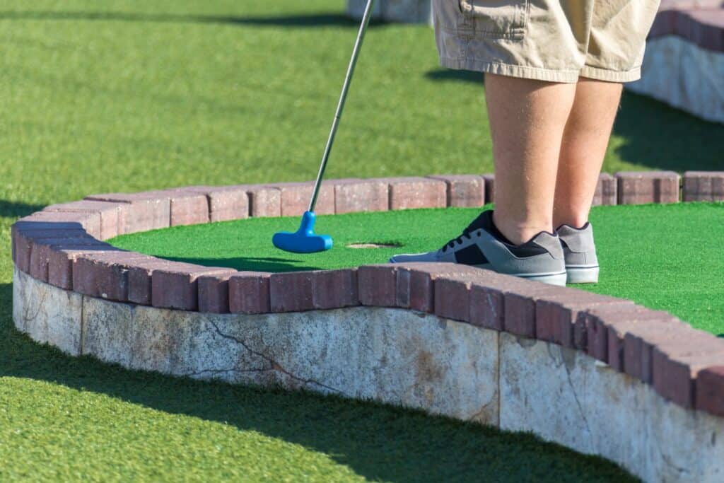 A man hit a golf ball at the club's course